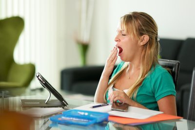 Woman yawning in the office