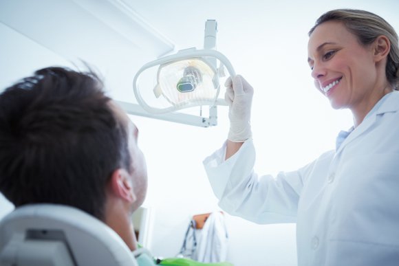 Lady dentist checking a patient