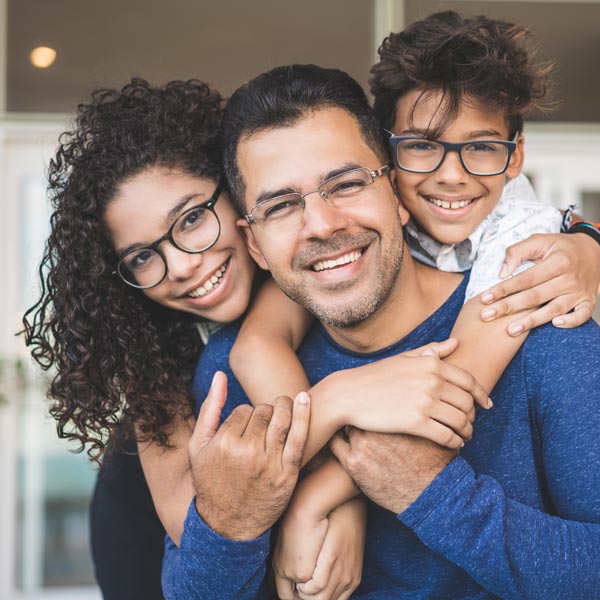 smiling father with two children