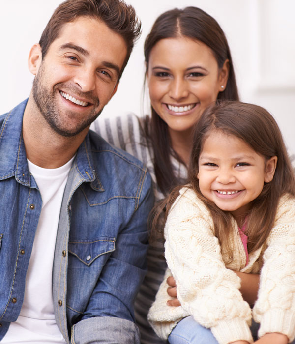 smiling family of three