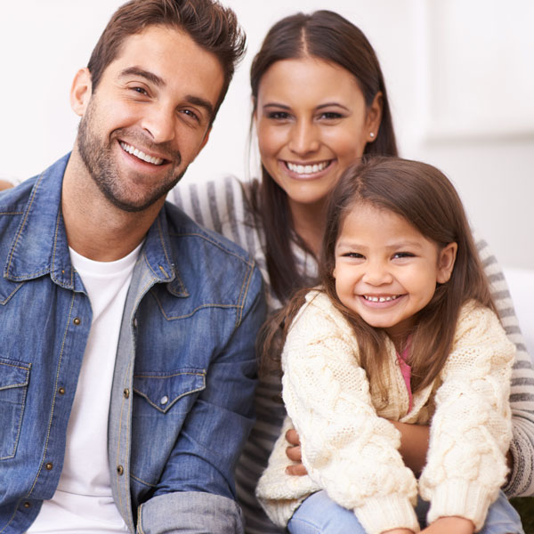 smiling family of three