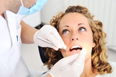 Dentist checking girl's teeth